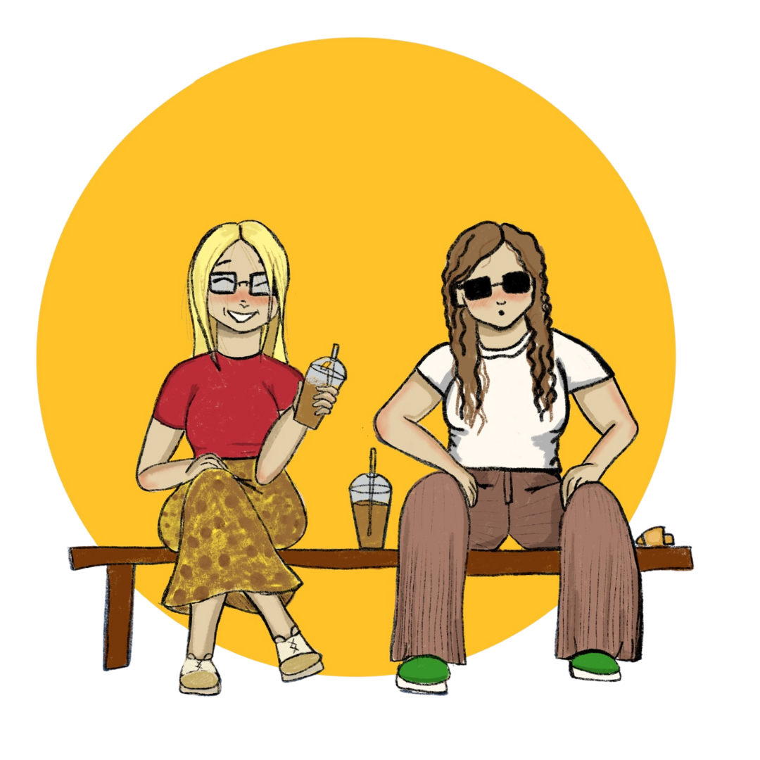 Two women drinking iced coffees while sitting on a bench